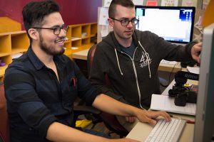 Two students using the computer at New 42.